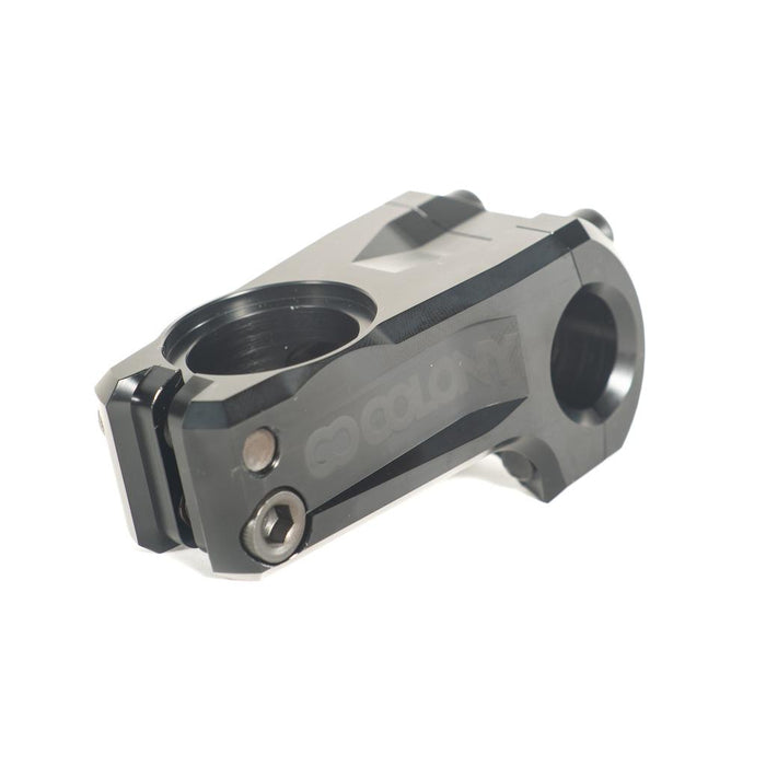 The Colony Official Front Load Stem (22.2mm Clamp) is a black BMX stem featuring prominent “Colony” branding, shown at an angle to highlight the bolt holes and clamping areas designed for handlebars and fork. Precision CNC machined from high-quality 7075T6 alloy, this sturdy stem ensures enhanced strength and durability.