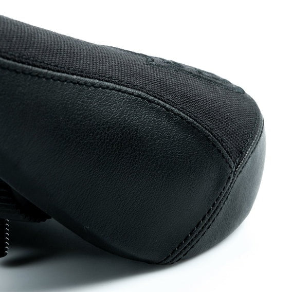 Close-up of the Federal Mid Stealth Logo Seat’s toe area, highlighting the durable black canvas top, smooth faux leather panels, and visible black embroidery stitching.