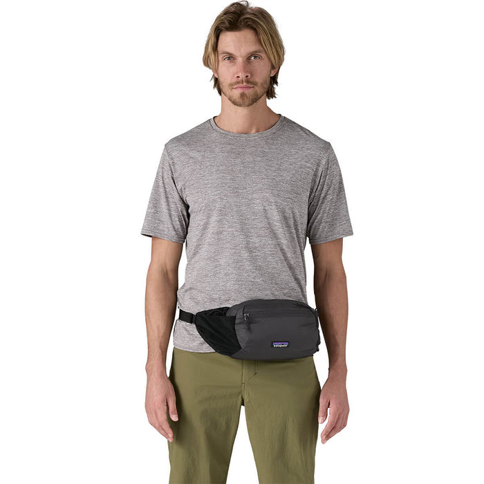 Black carried as hip pack at front by male model